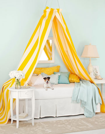 Make smart use of an embroidery hoop, attach ready made light weight curtains to the hoop and you have a canopy ready