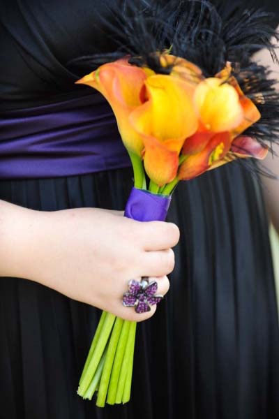 this simple bouquet of Orange calla lilies, black feathers and purple ribbon is perfect.