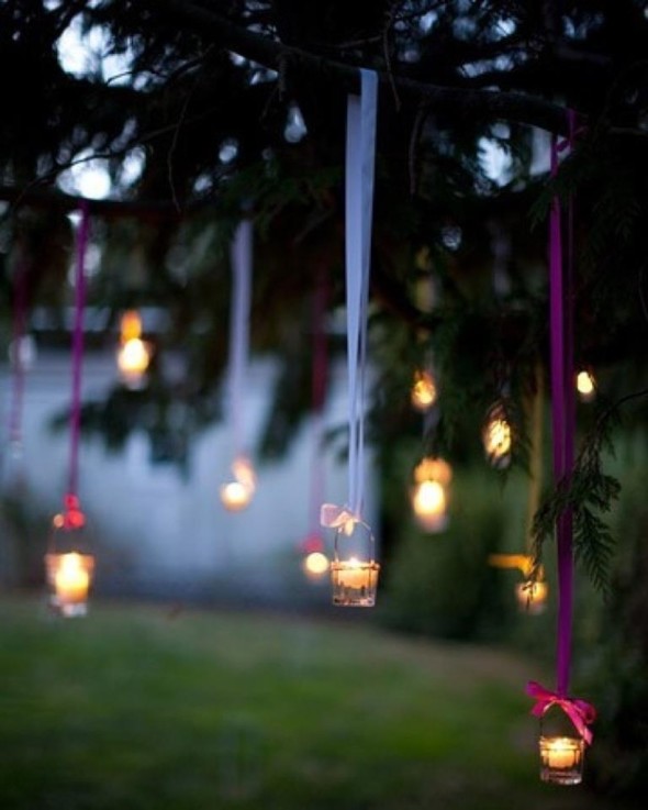 hang tea lights from a tree with colorful ribbons and pretty bows