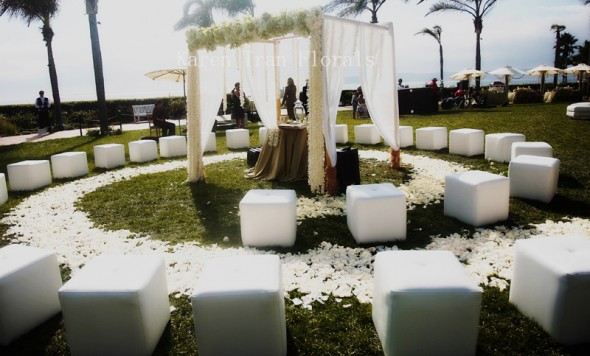White seating provides an elegant, uniform look that makes the most of the natural floral and greenery, also it gives a unified look to the ceremony decor. 