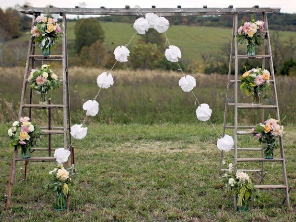 Simple wooden ladder can be turned into a beautiful archway with floral bouquets on the steps
