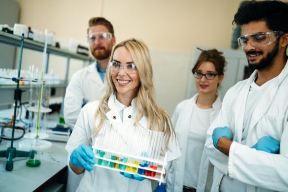 Group of young successful scientists posing for camera